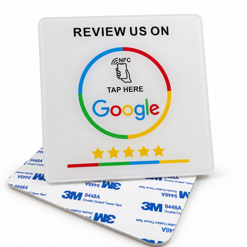 Black acrylic NFC Google review plaque shown upright beside a separate plaque with 3M adhesive backing facing up
